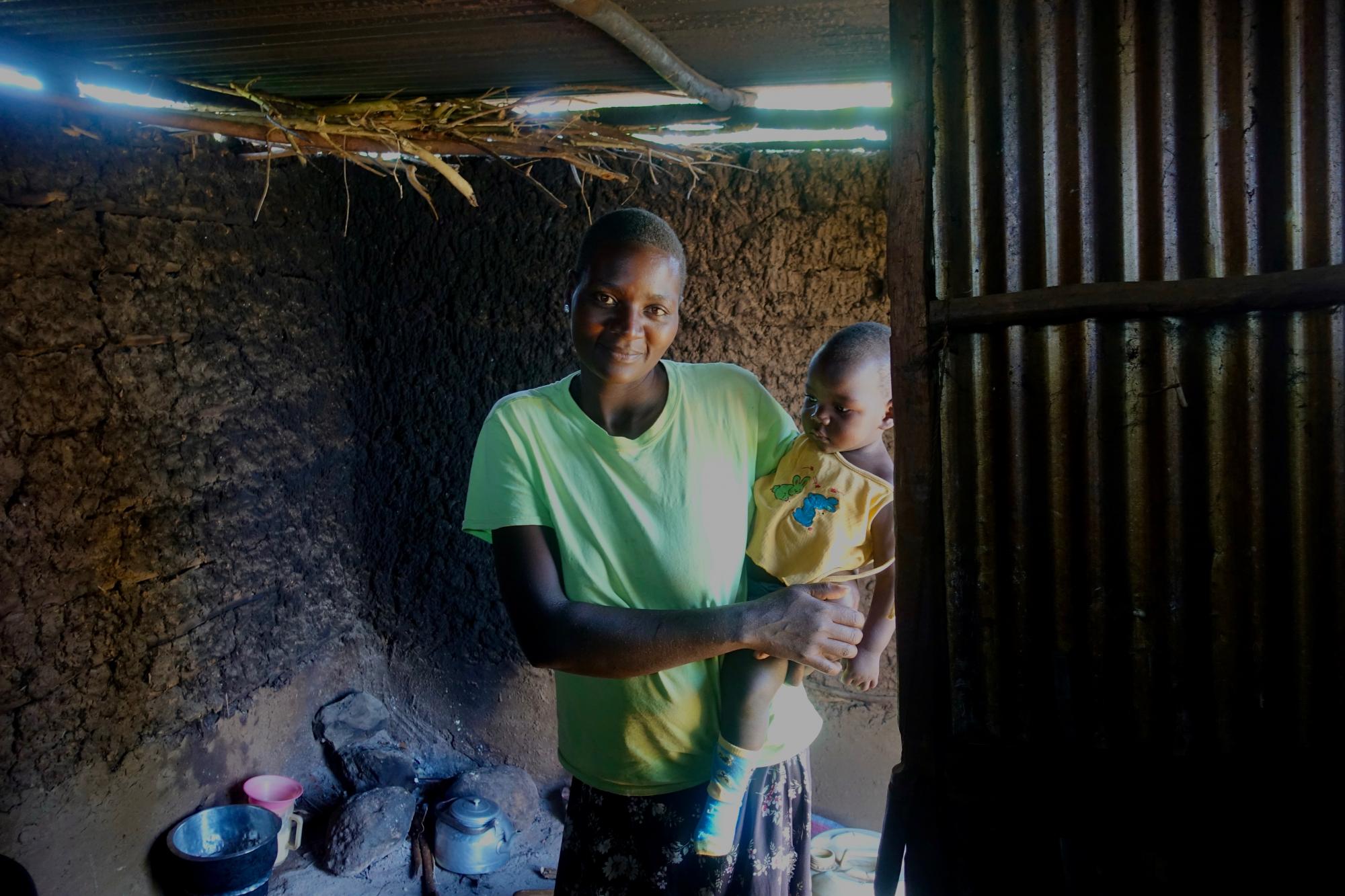 Photo 10: Woman with child inside a house.